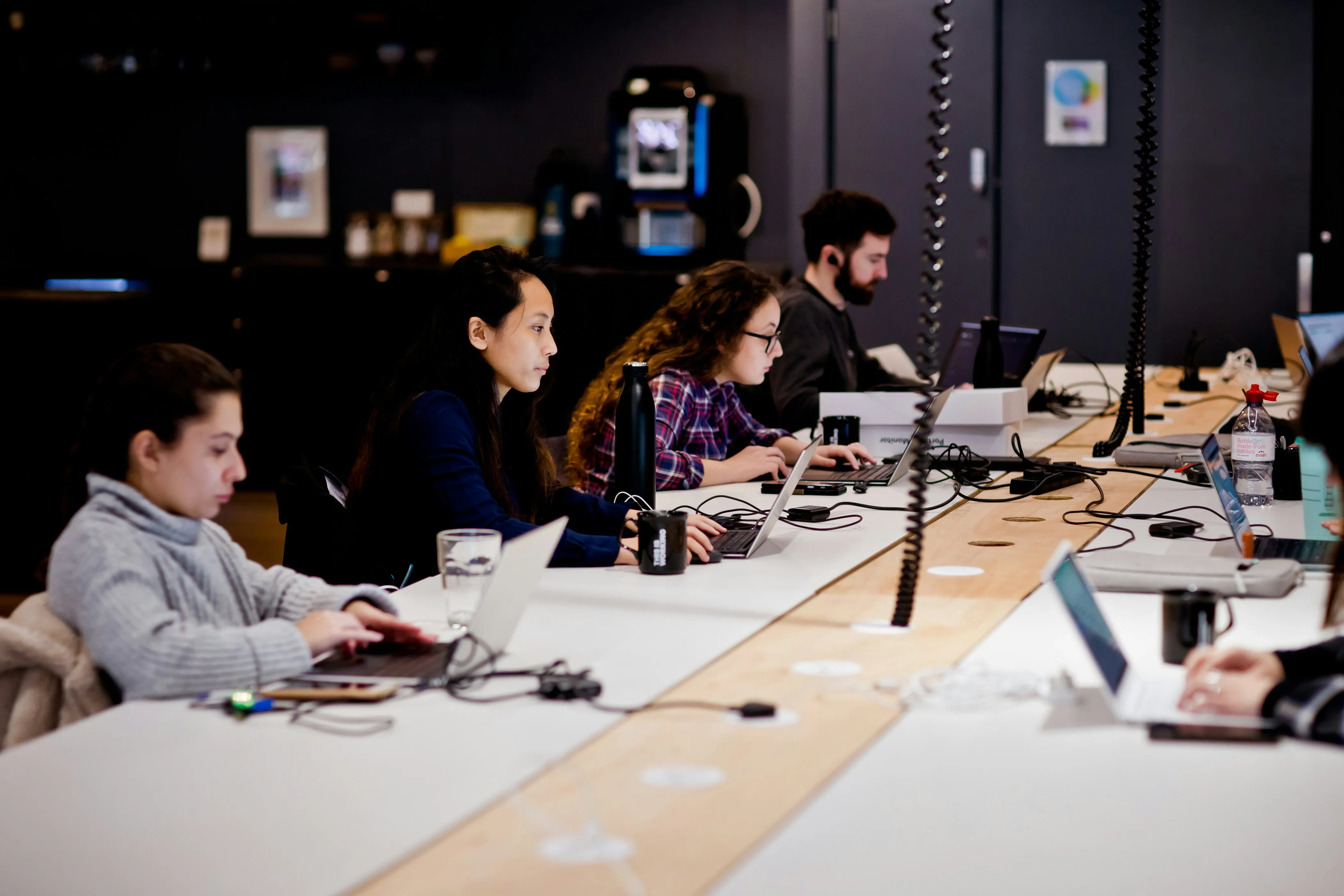 young people in co working space with their laptops