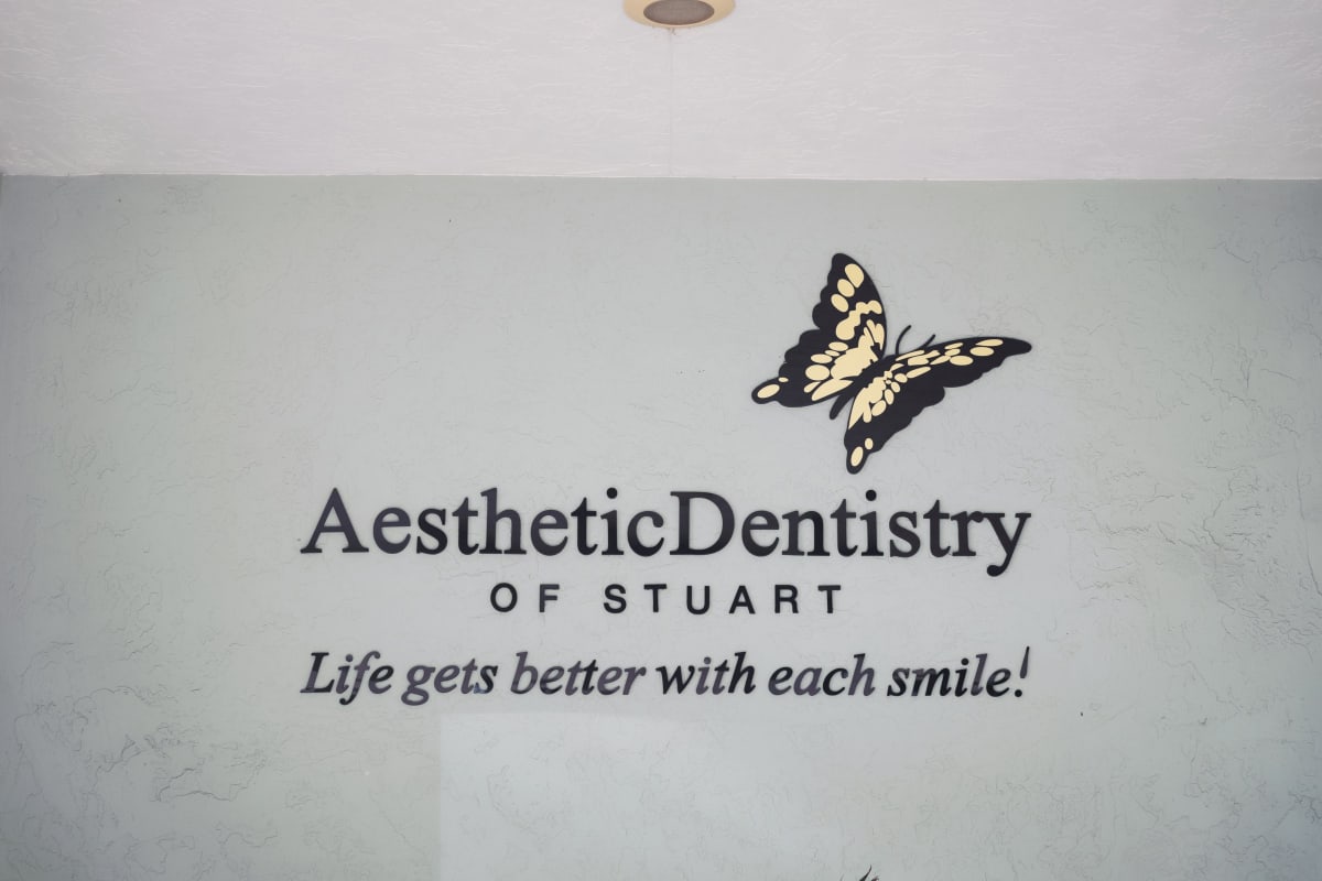 Aesthetic Dentistry of Stuart logo and branding on office wall with tagline