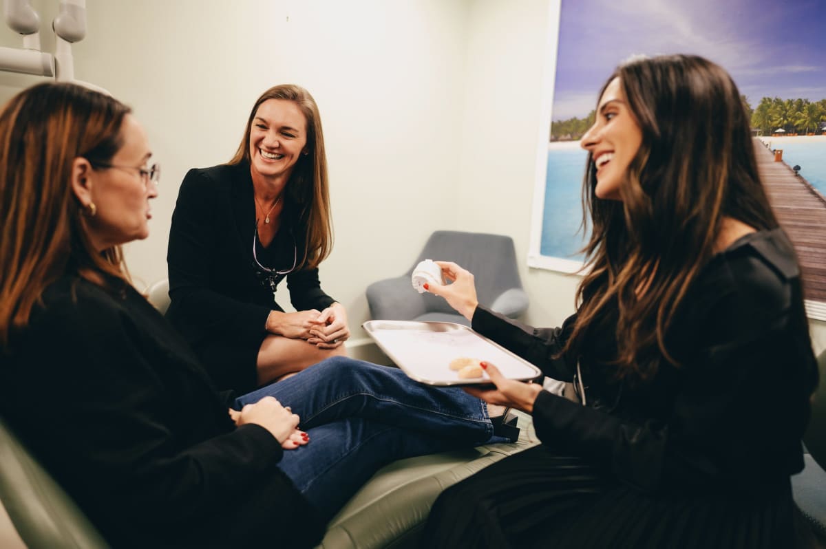 Dentist discussing treatment plan with patient in consultation room