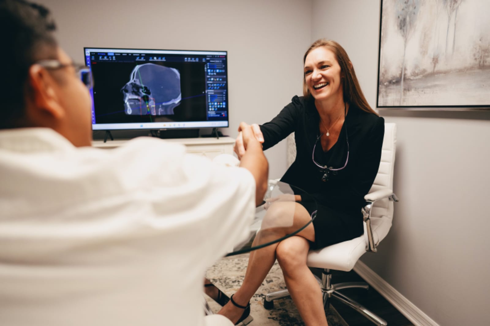 Dentist showing digital scan results to patient on tablet