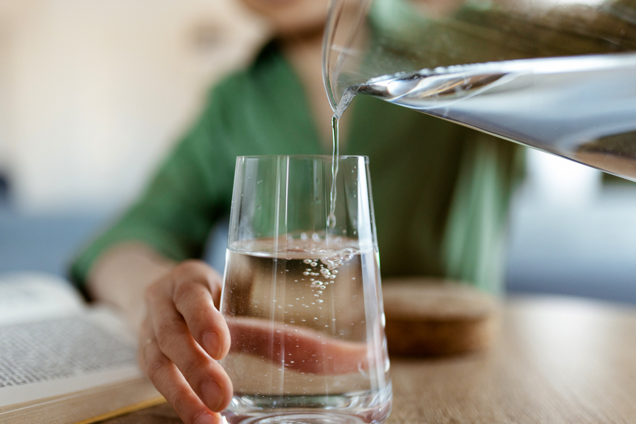 pouring water into glass 
