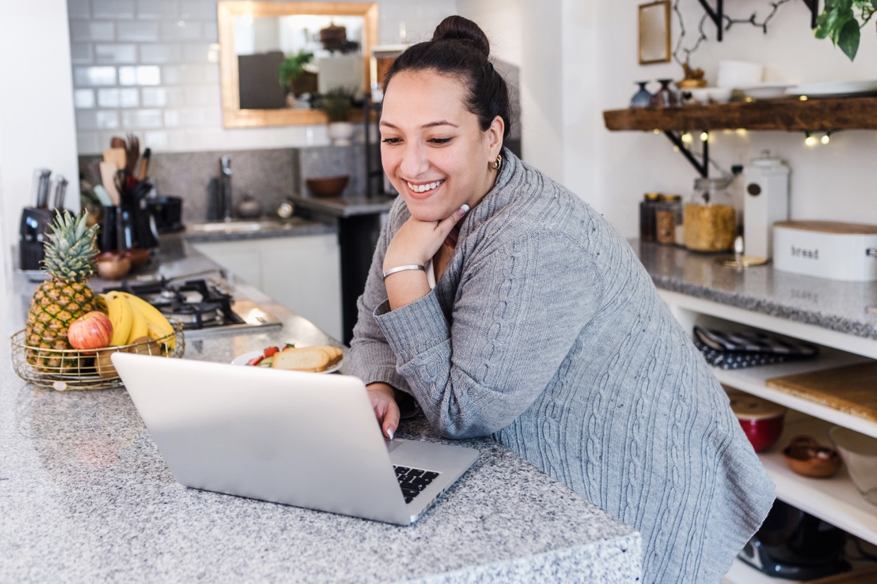 Woman on computer smiling
