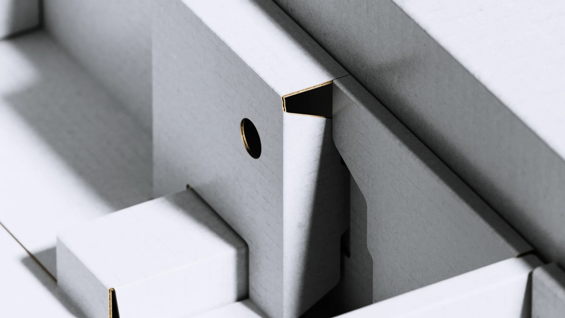 Macro of the white cardboard inserts inside the XBOX packaging, with a die-cut finger hole and folded partitions