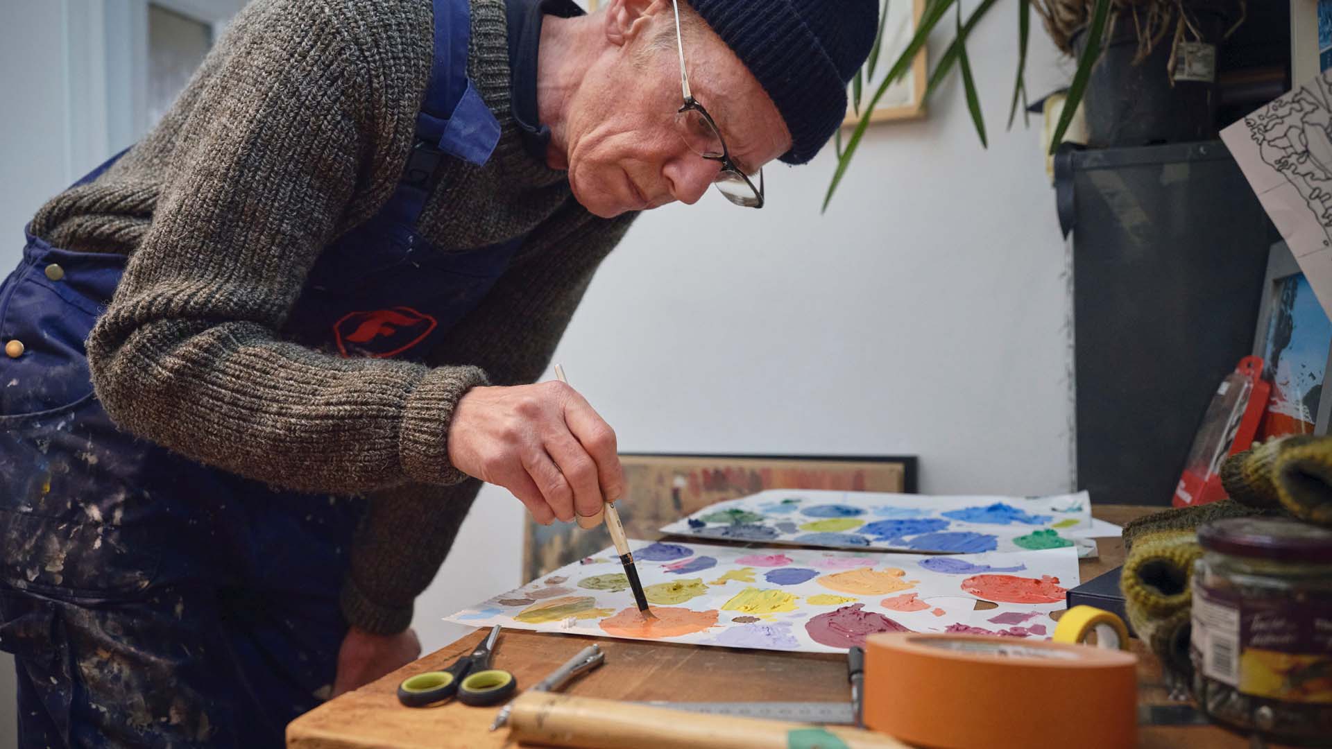 a man painting on a table