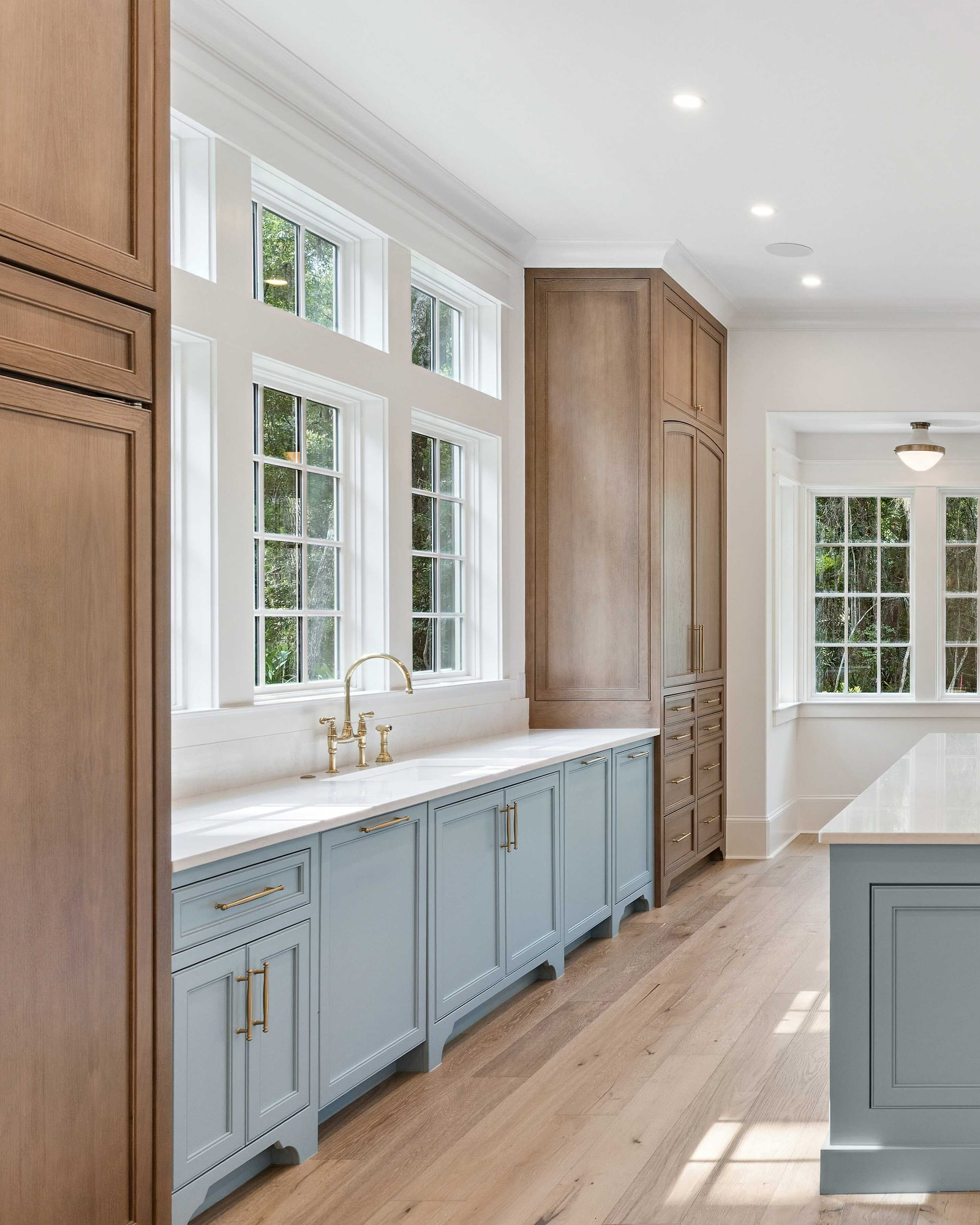 Moss Grove, Flanagan Development, St. Simons Island: kitchen with blue cabinets and brass fixtures