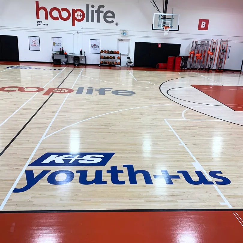Image of HoopLife Gymnasium with K+S Youth+Us Logo in Gym Floor