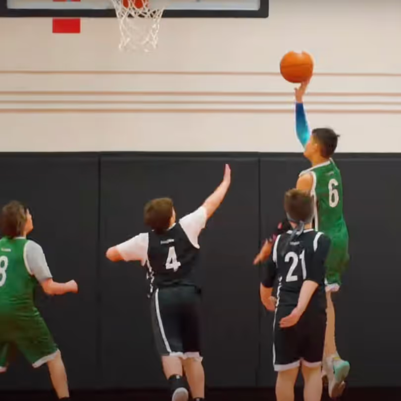 A basketball player laying up the ball