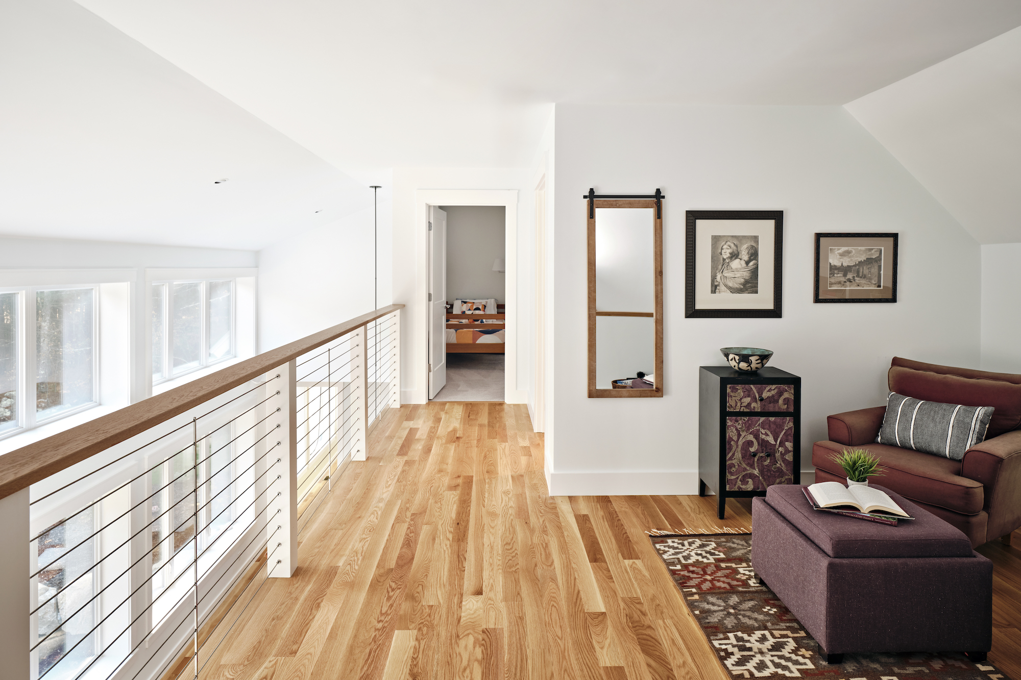 Modern loft interior with wooden floors, white walls, and cozy living area