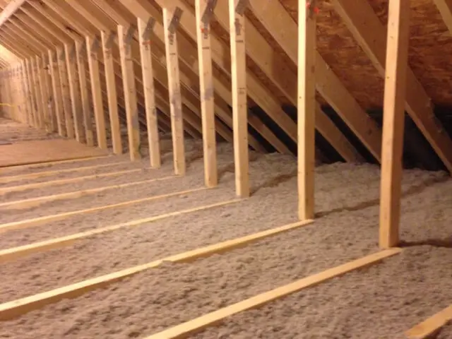 Wooden roof trusses and insulation in an unfinished attic space