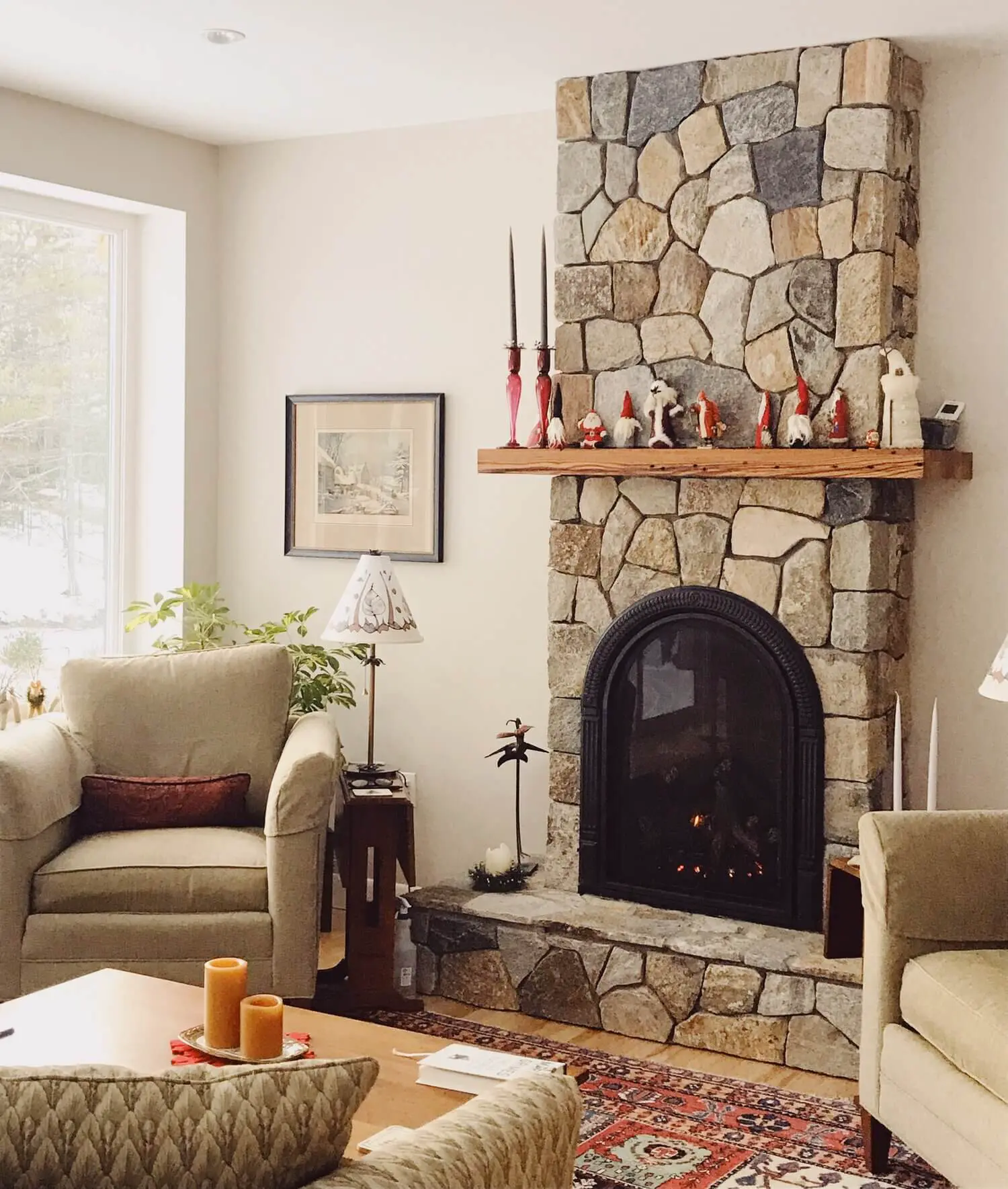 Cozy living room with stone fireplace, gnome decorations, and warm lighting