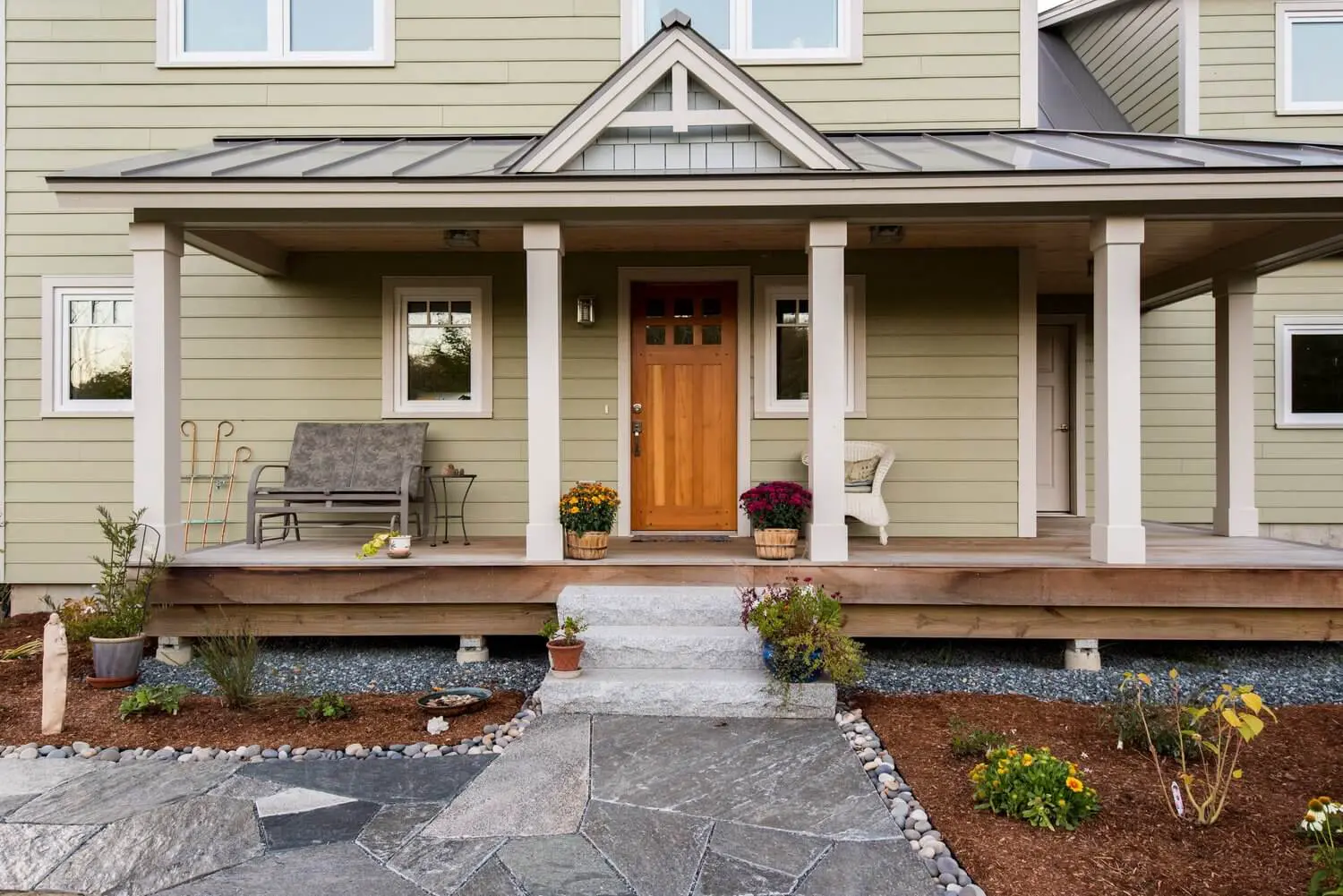 Craftsman-style home with wooden front door and welcoming front porch
