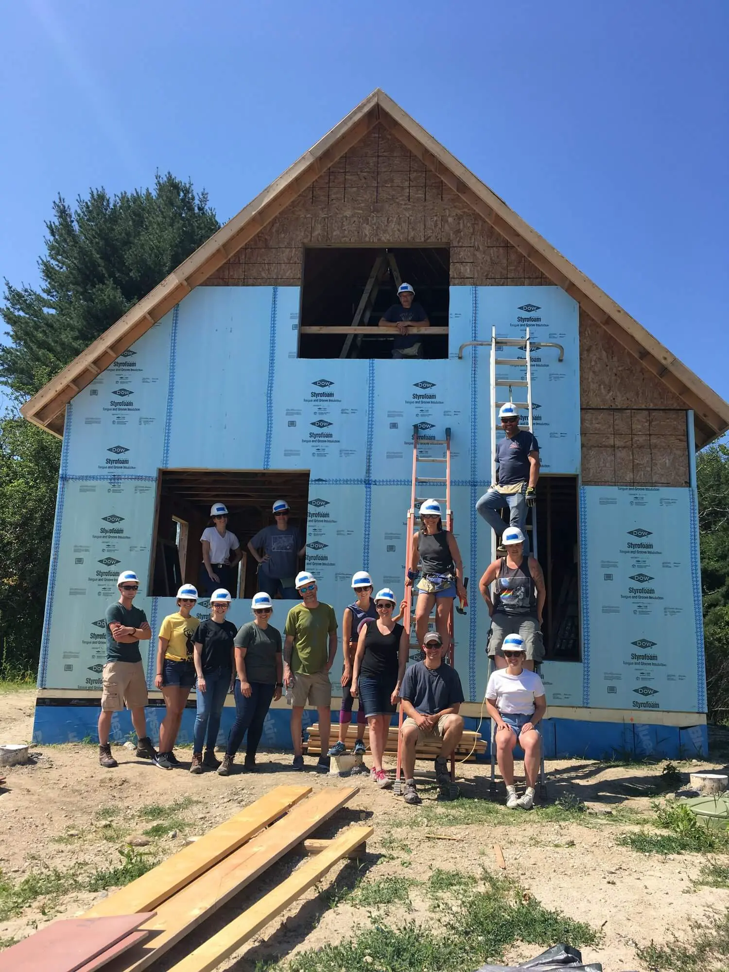 Construction team working together on building a wooden frame house