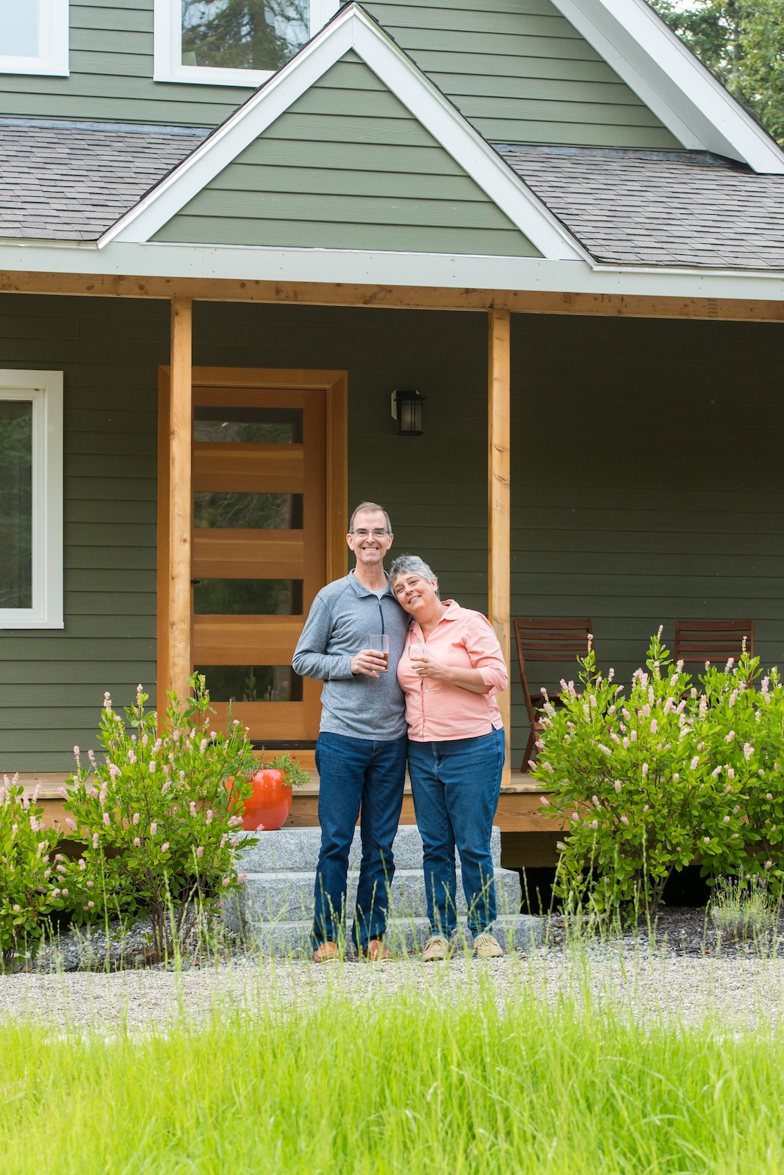Happy BrightBuilt Homeowners standing in front of their custom home design