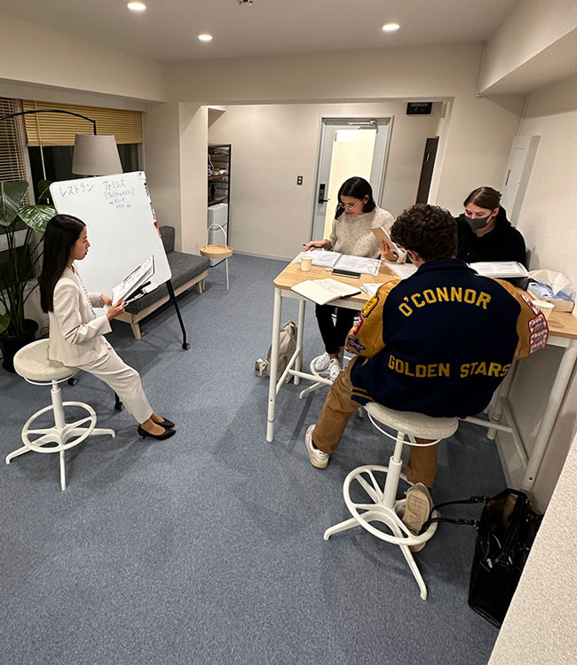 Japanese language lesson during an internship in Japan, with teacher and interns in a classroom setting