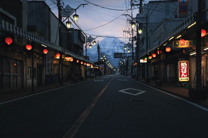Empty street in Japan with red lanterns and Mt. Fuji in the distance at dusk