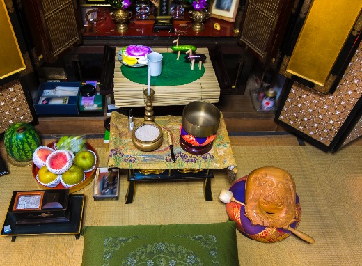 A home altar with offerings of fruit, vegetables, and candles prepared for Obon.
