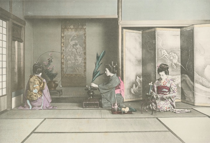 Vintage photo of women practicing ikebana flower arrangement in a traditional tatami room.