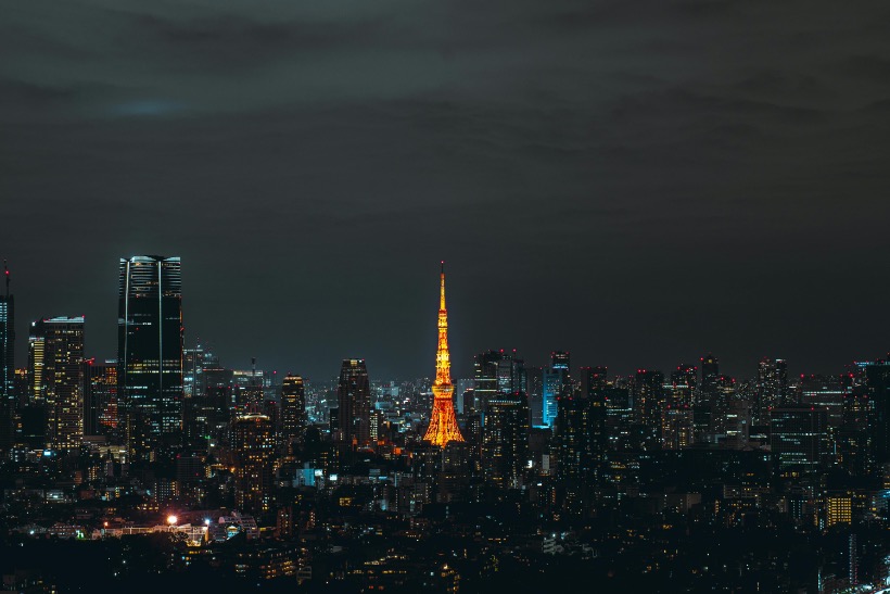 Tokyo skyline at night with Tokyo Tower glowing in the center.