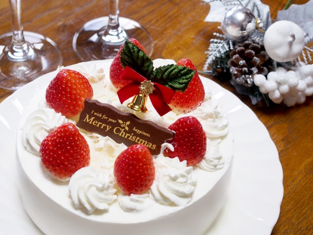 Japanese-style Christmas strawberry shortcake topped with whipped cream and festive decorations.
