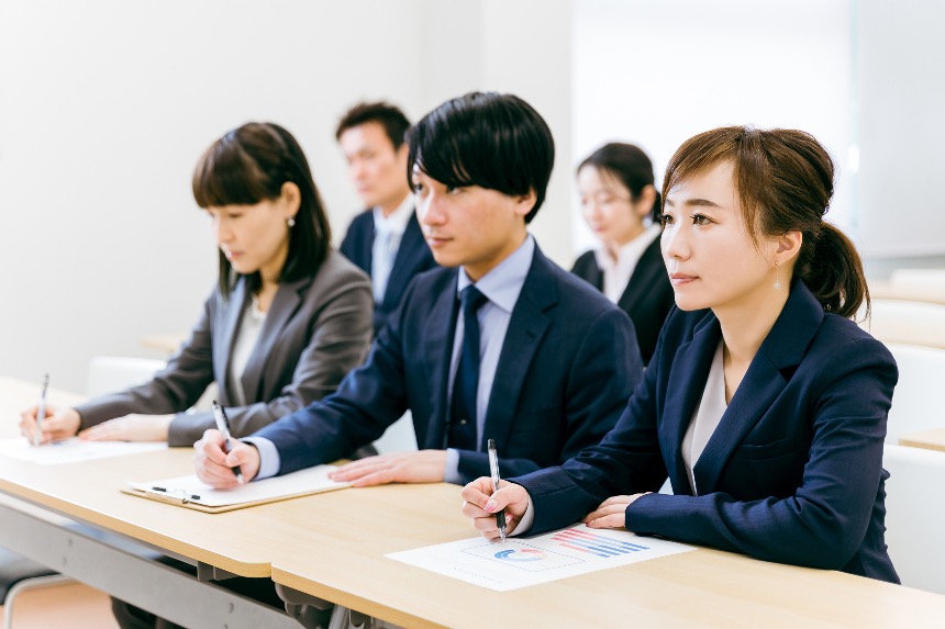 Japanese business professionals attending an in-office training presentation.