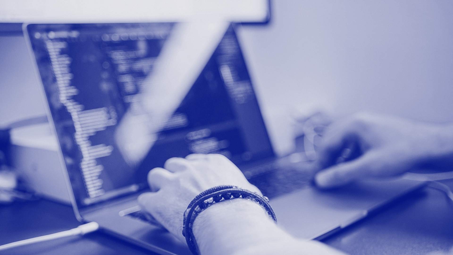 A man working on a computer, managing data talent integration