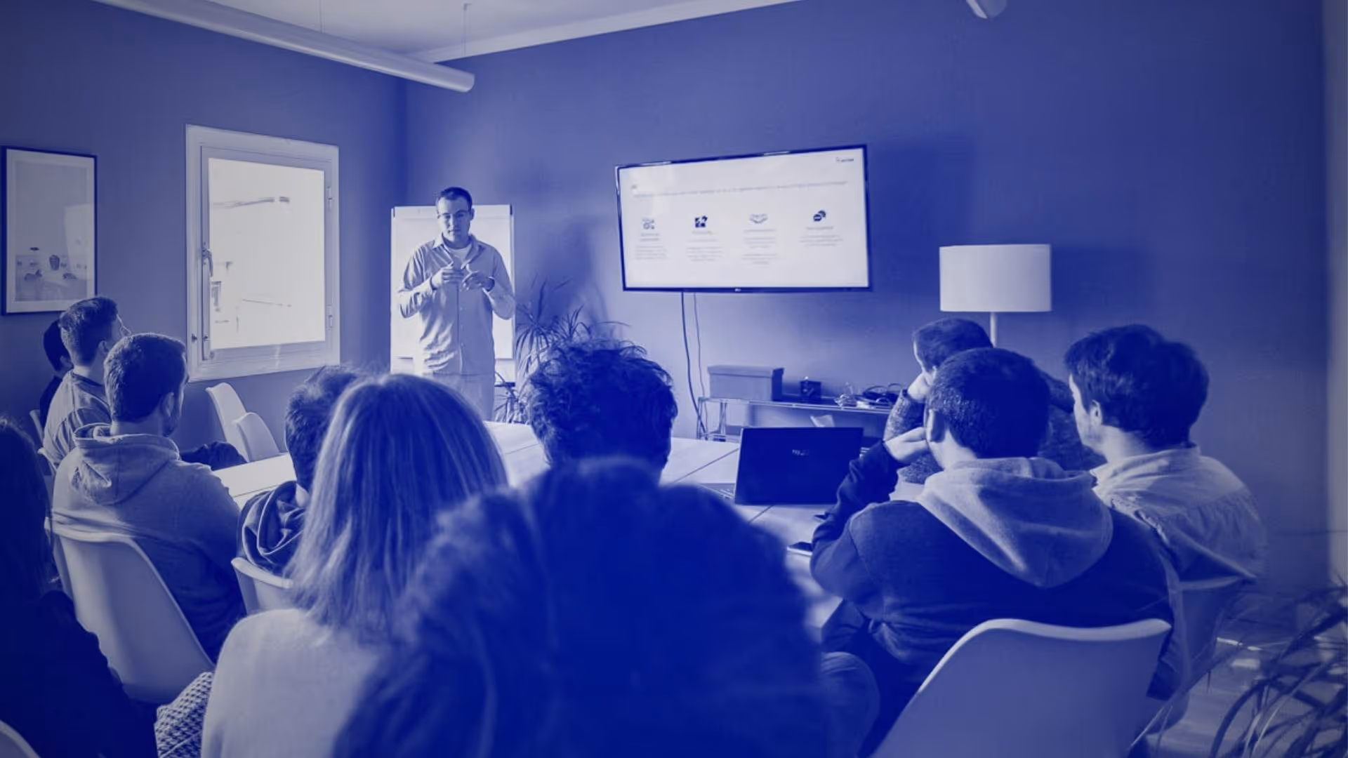 A facilitator delivering a training on AI and data to a group of people
