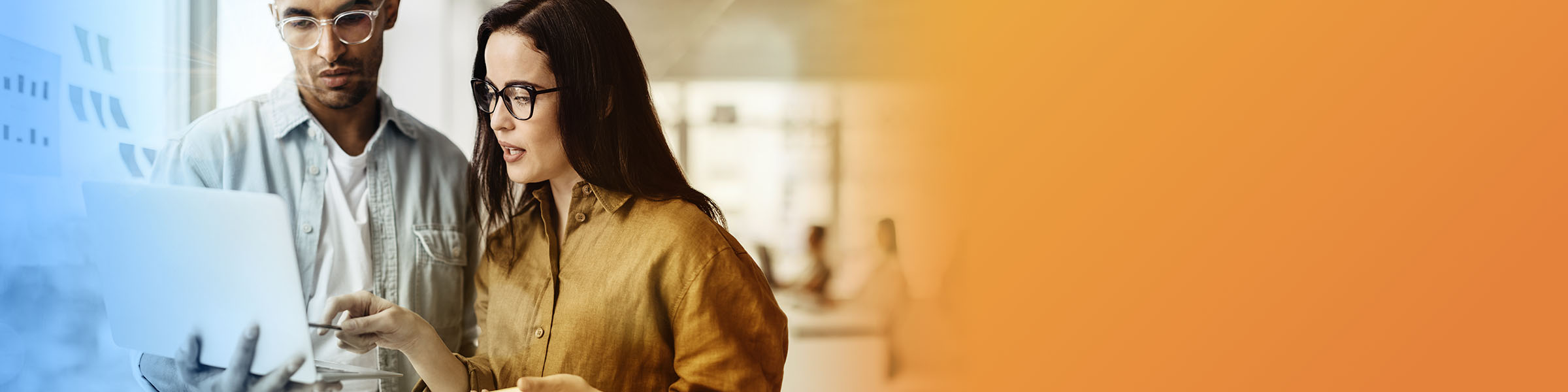A diverse group of professionals looking over paperwork and smiling.
