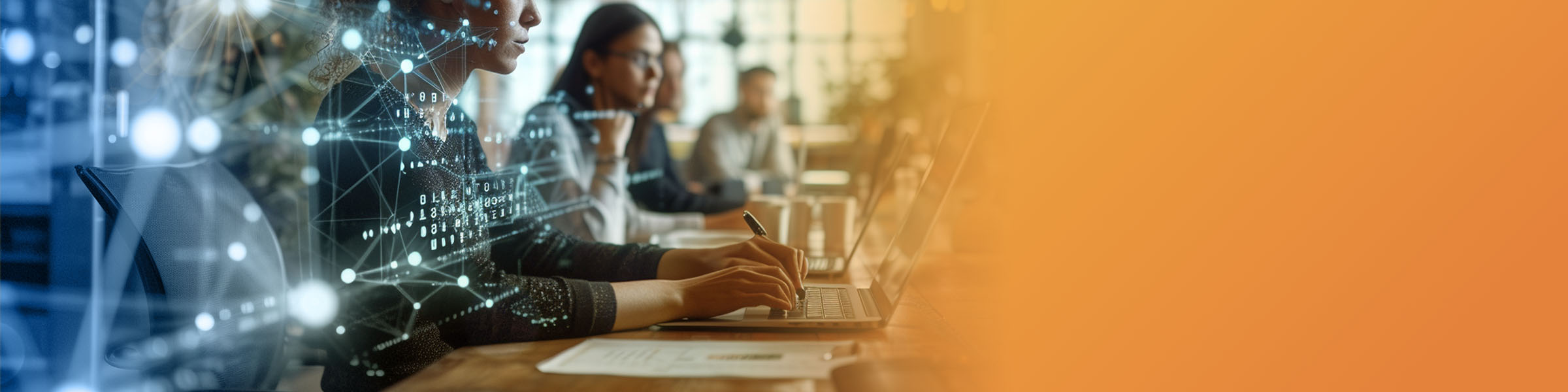 Two Lighthouse employees review documents at a table in the office.