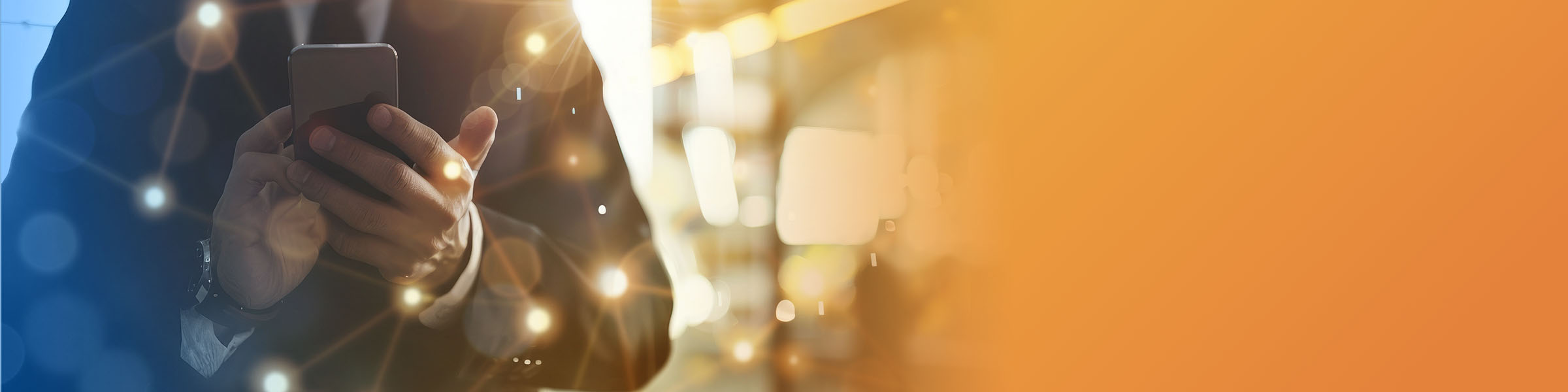 Two diverse women smiling and pointing at a laptop screen in their office.
