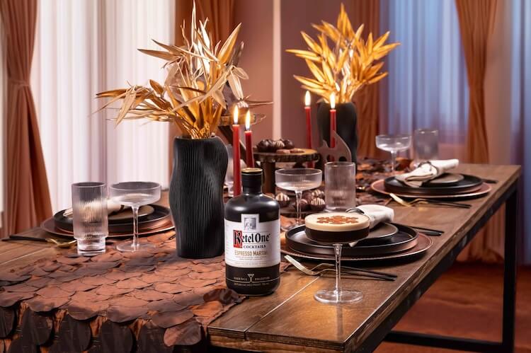 Black vintage film camera with a flash on a wooden surface surrounded by photographs.