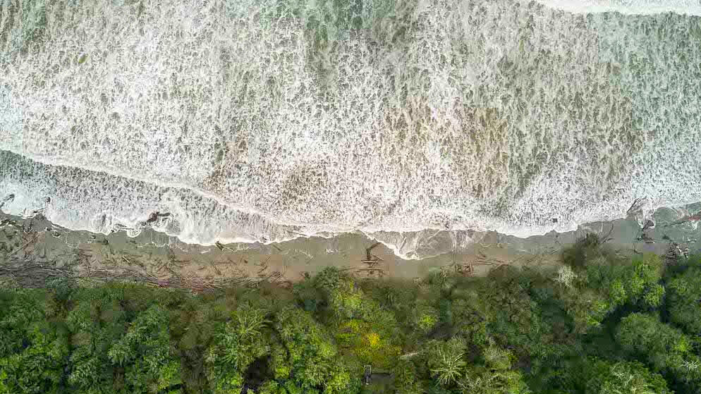 Areal view of waves crashing onto the beach on the shores of victoria bc