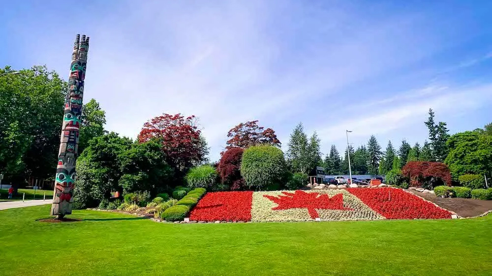 A Canadian Flag made from flowers in front of the BC Parliament Buildings in Victoria BC