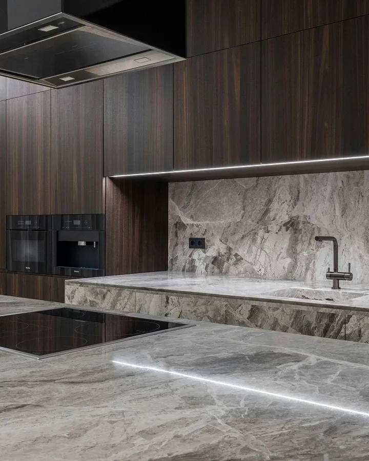 Veined brown quartzite stone countertops with rich wood cabinets.