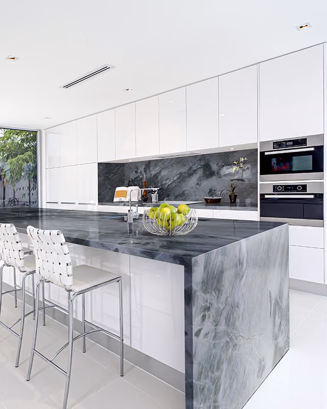 Marble And Granite Tech - Quartz countertops with veining 2026 Sleek modern kitchen featuring Acquatic Quartzite countertops and backsplash,