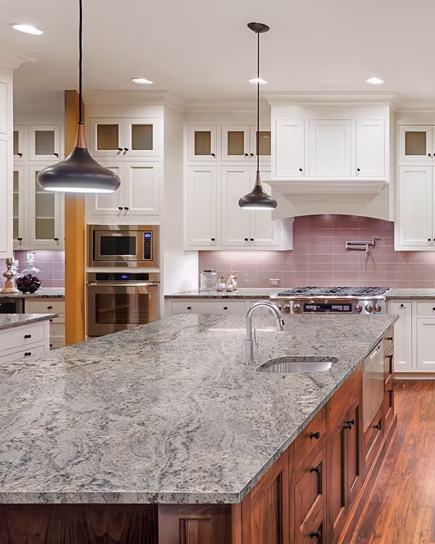 Bright kitchen with white cabinetry and soft gray Nevaska Granite countertops Surfaces By Pacific