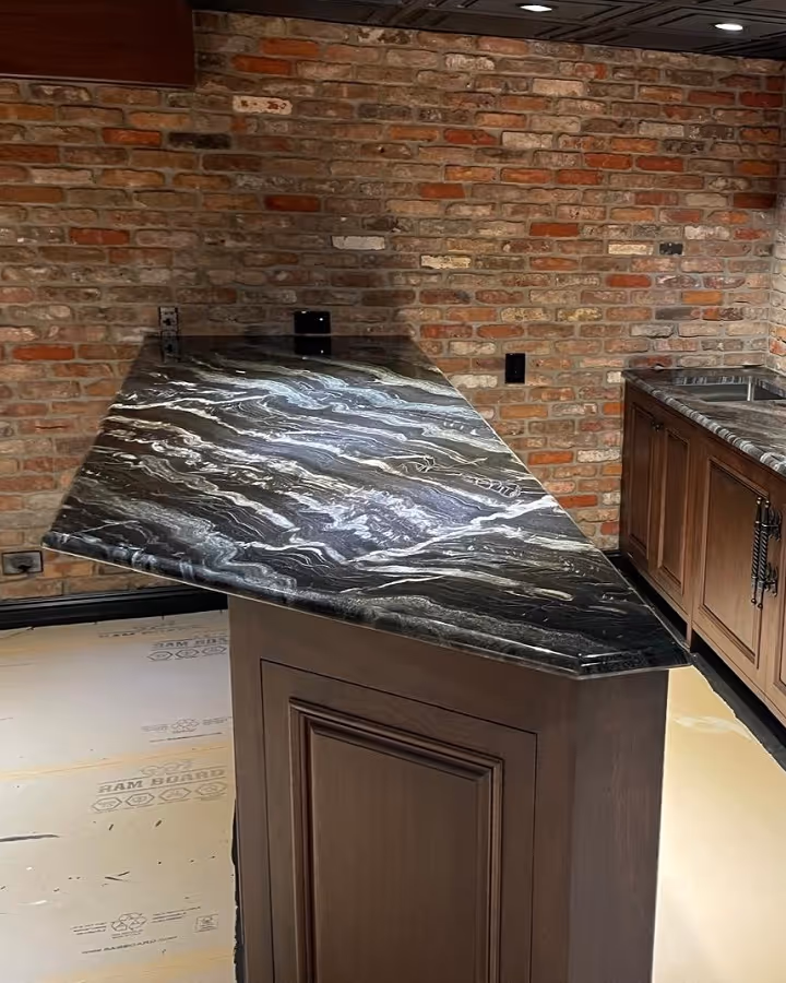 Luxury home bar with angled black granite countertop