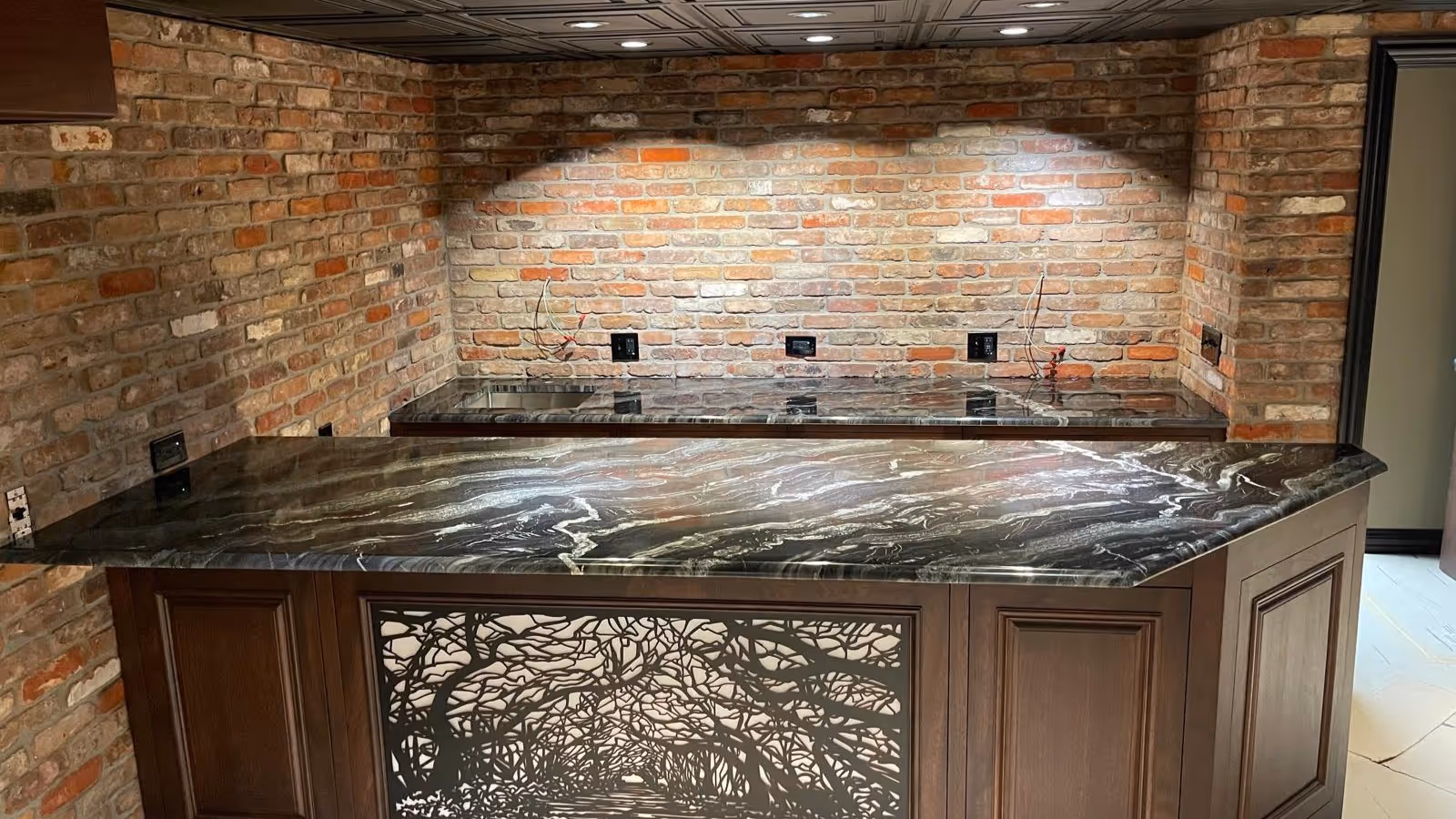 Luxury home bar with angled black granite countertop