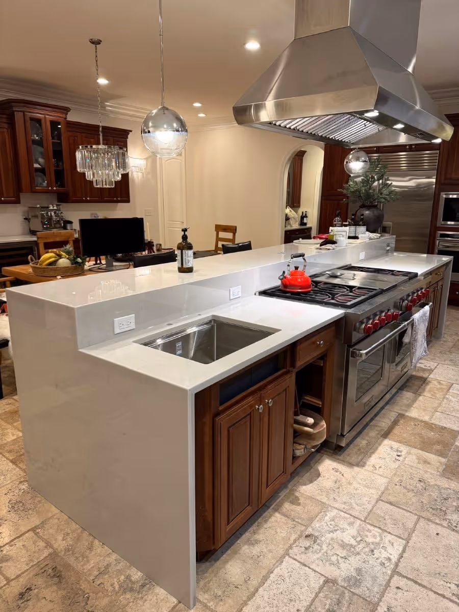 Marble And Granite Tech - Marble And Granite Tech - Quartz Kitchen Island, Integrated Cooktop Polished quartzite kitchen island with a full-height waterfall edge and classic wood cabinets.