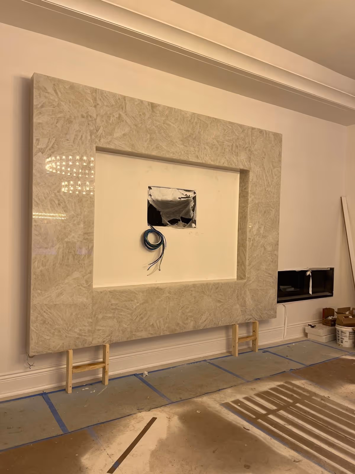 Full wall surround for entertainment center in Oak Brook clad in Pure Clear Natural Quartz with large cutout for TV and media wiring.