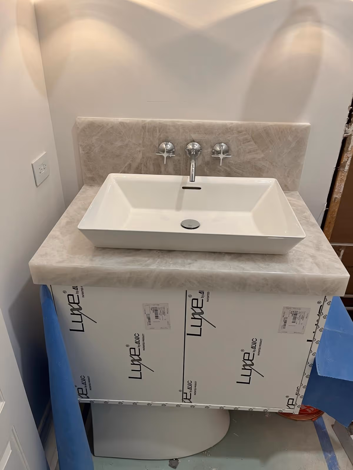 Small floating bathroom vanity with Pure Clear Natural Quartz countertop and backsplash in Oak Brook featuring a modern vessel sink.