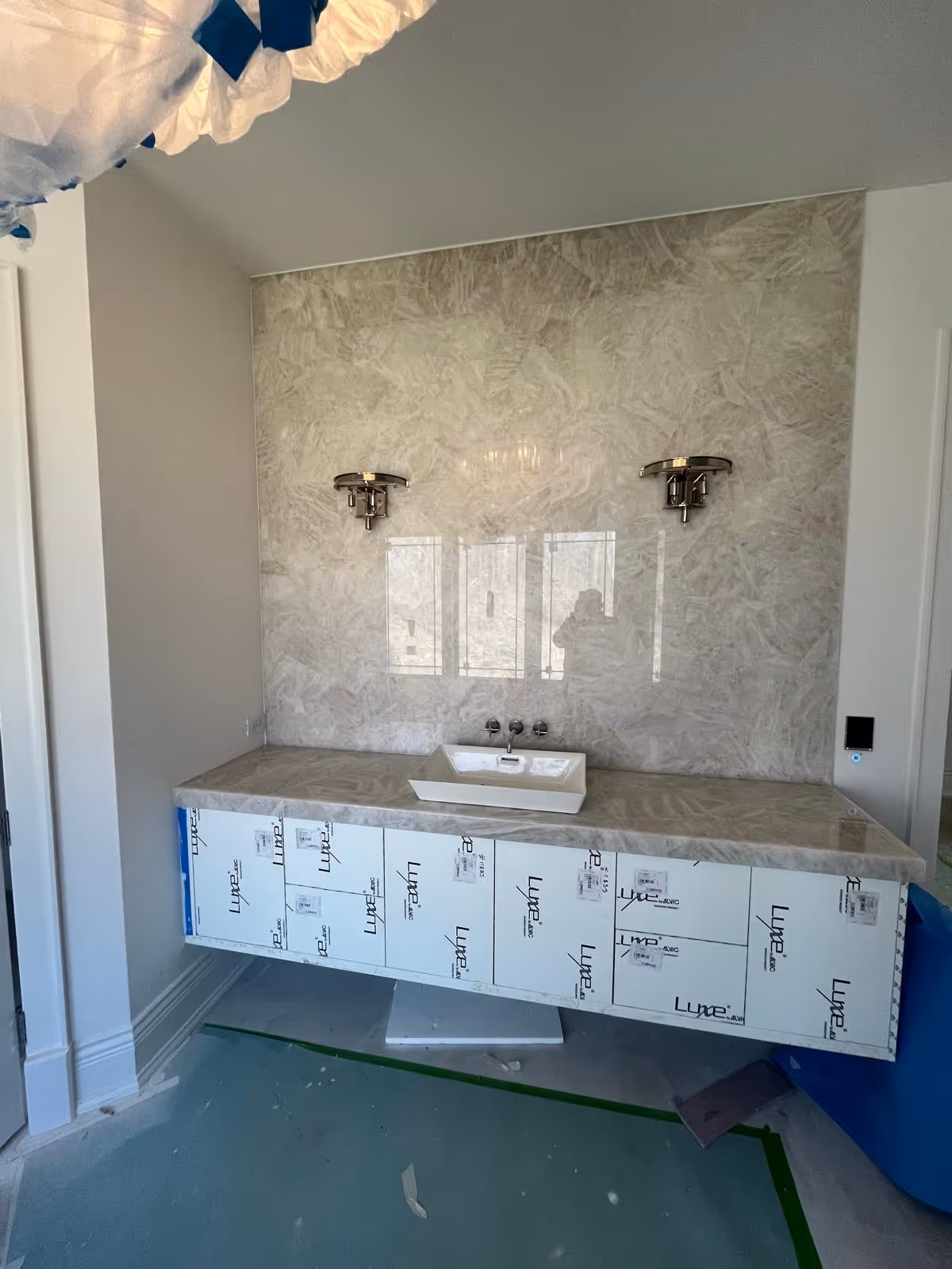 Master bathroom floating vanity in Oak Brook with Pure Clear Natural Quartz countertop and full-height wall panel for a seamless design.