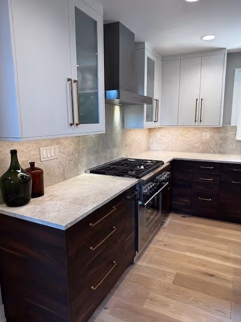 Close-up of Taj Mahal Quartzite countertops and full-height backsplash with soft beige tones in a modern kitchen setup.