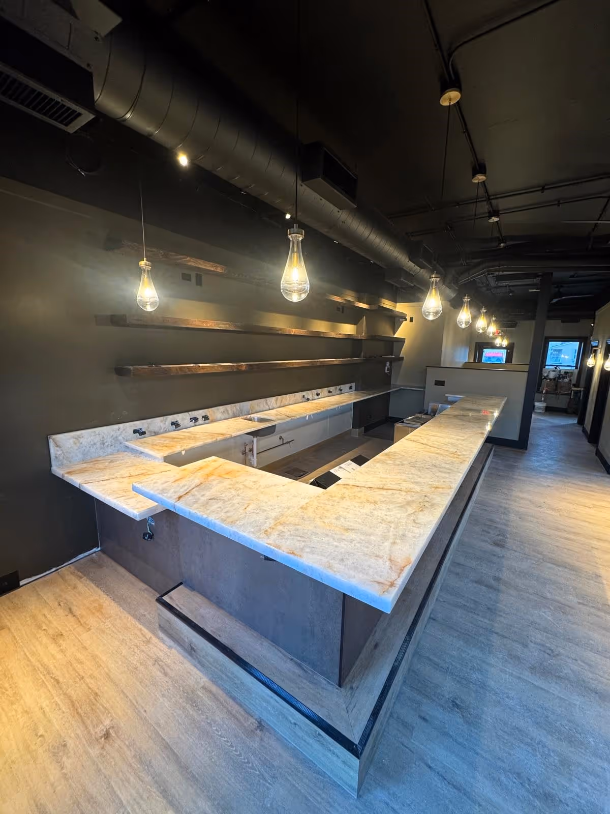 Crystallo 2-Inch Mitered Bar Countertop - Chicago Area Wraparound Crystallo bar countertop with brass - colored porcelain under bar section