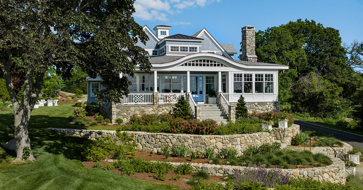 A coastal home perched on the slope of the site looking over the harbor.