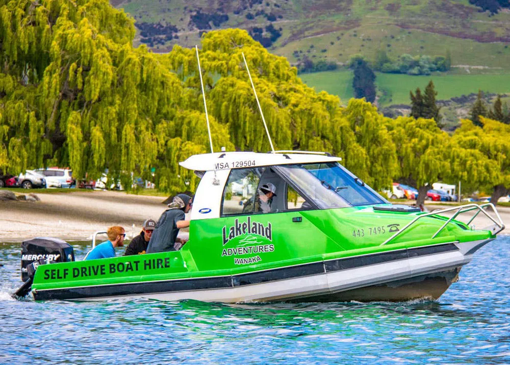 Green Hire Boat diving on Lake Wanaka with a group of friends