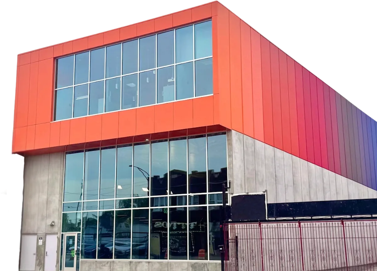 The BPNC Service Center: a two-storey building with orange-to-blue gradient cladding above a glass ground floor.