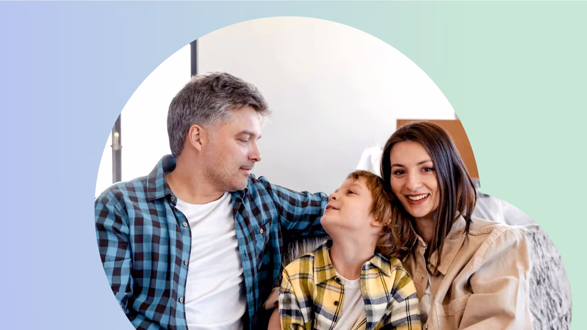 A picture of a family consisting of a man, a woman, and a young kid sitting on the couch.