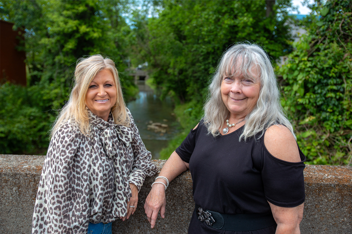 Mayor Kathi May and local resident Donna Brewer posing on the Campton, Kentucky bridge that will soon be renovated with the help of GRANT Program matching funds.