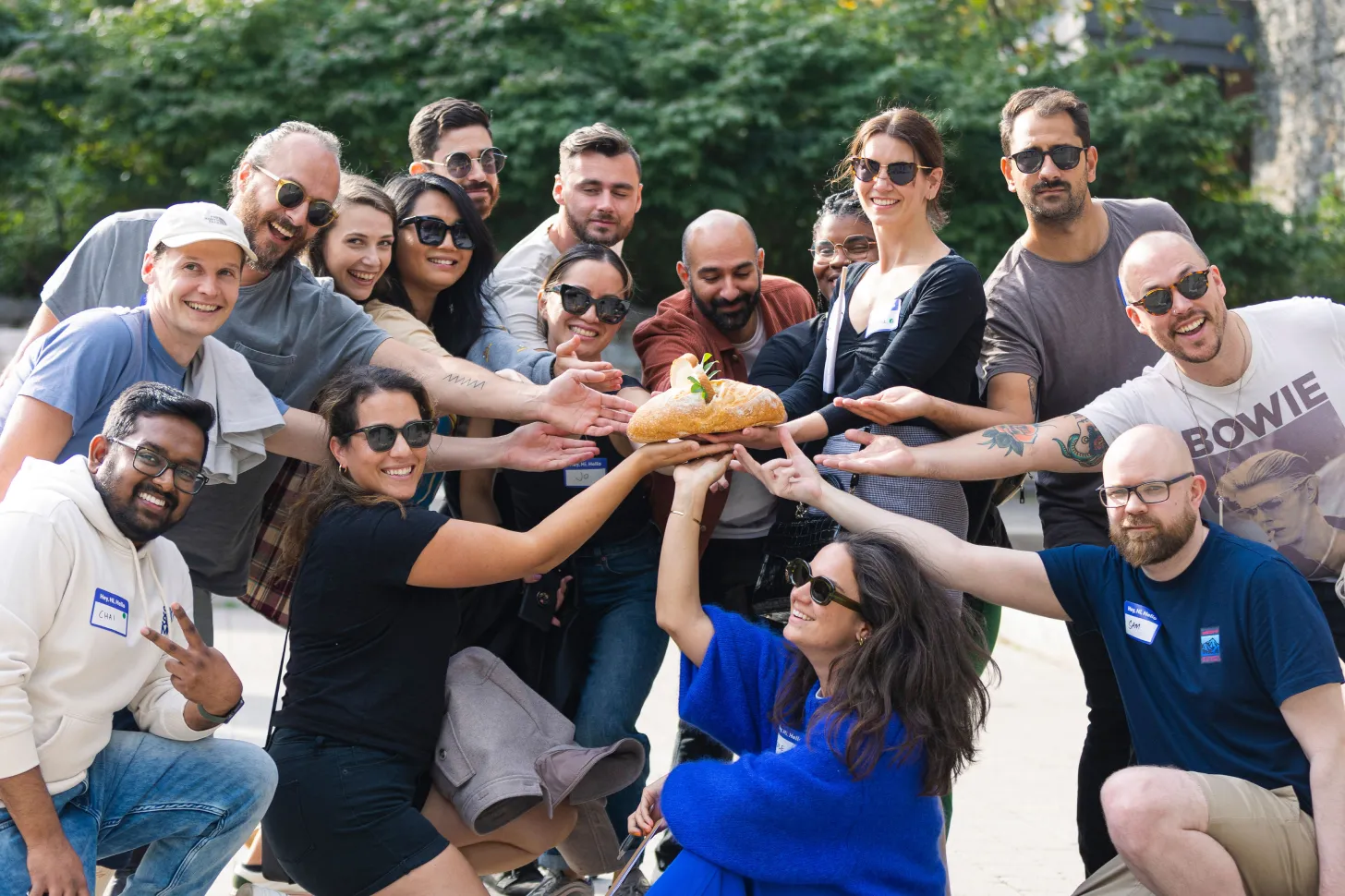 photo of The Beam team holding a loaf of bread in a moment of relaxation.