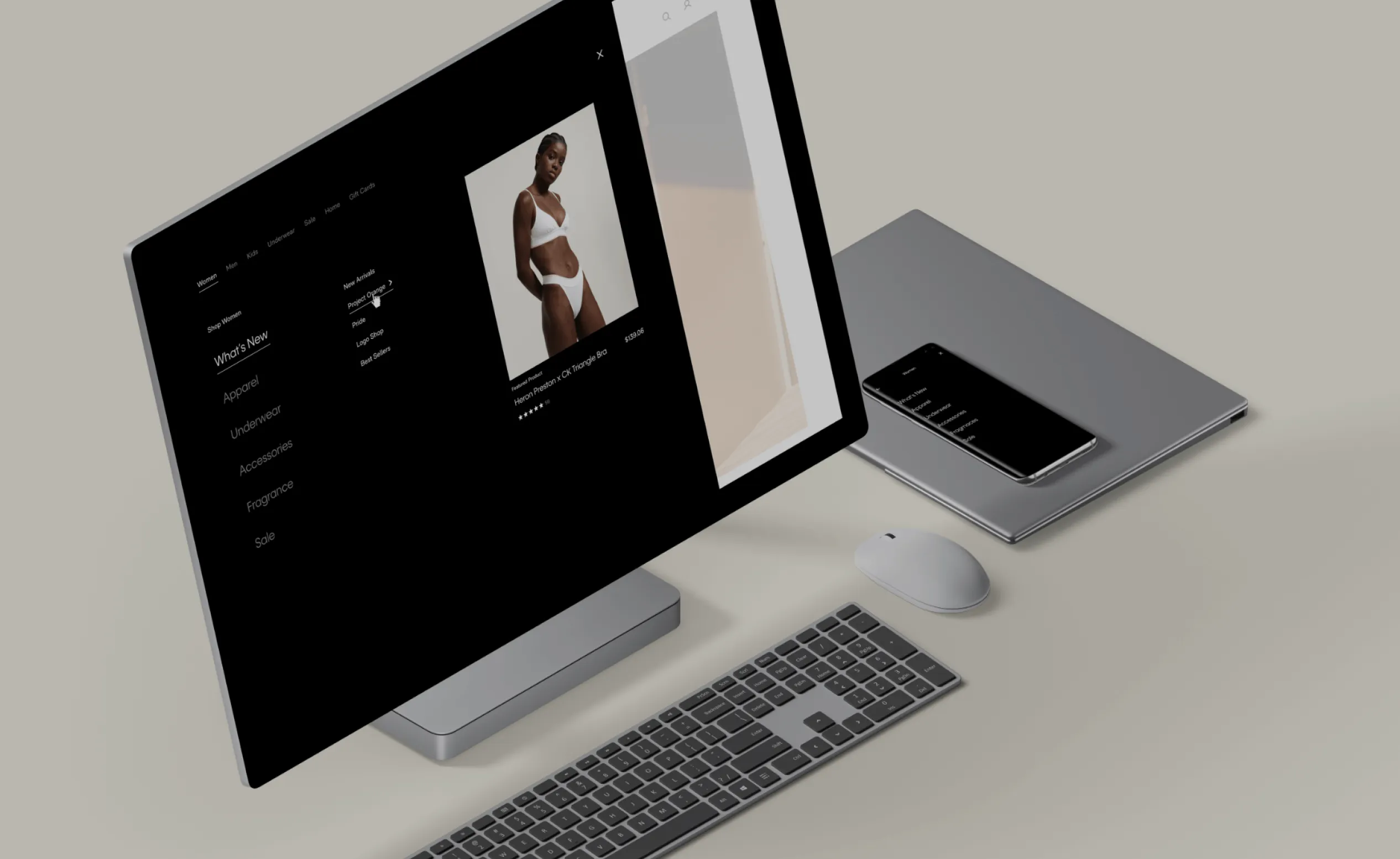 Image of a computer showing a page from the Calvin Klein website. Next to it, we have a tablet and a cell phone.